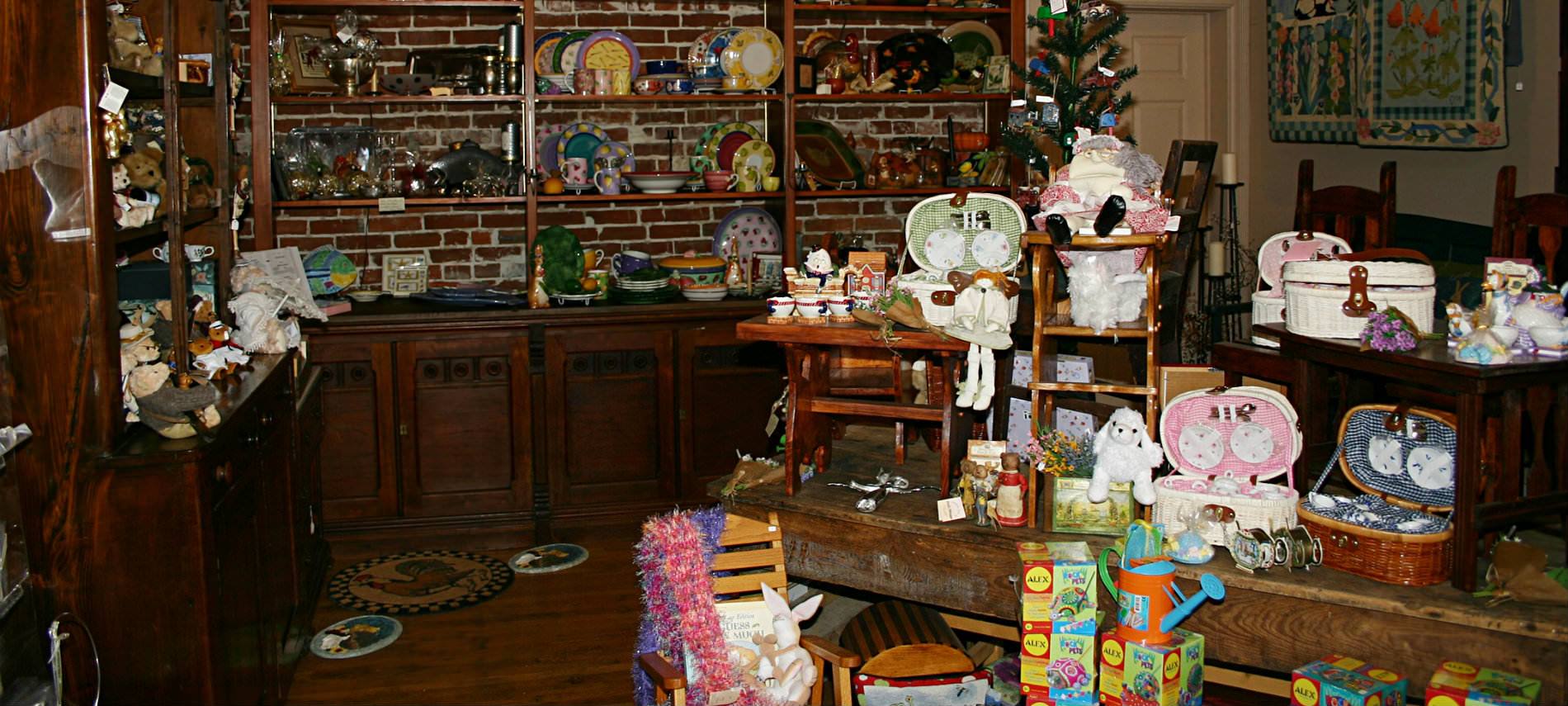 Room with wooden shelves, cabinets and tables with a variety of merchandise of all types.