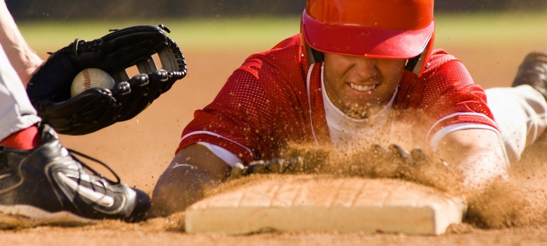 Baseball player sliding into home base